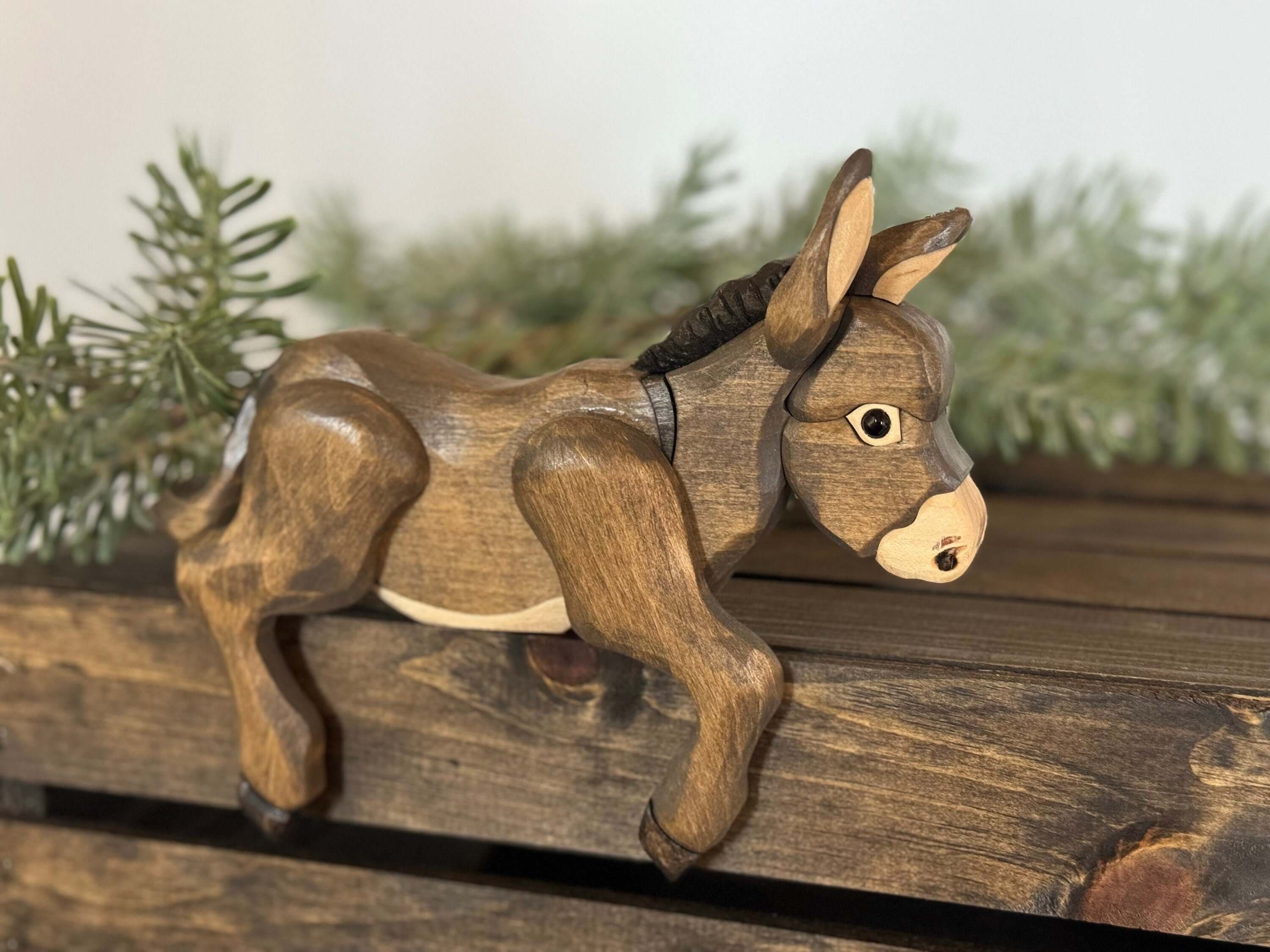 Handmade Wooden Donkey Shelf Sitter | Rustic Farmhouse Donkey Decor on a wooden shelf with greenery.